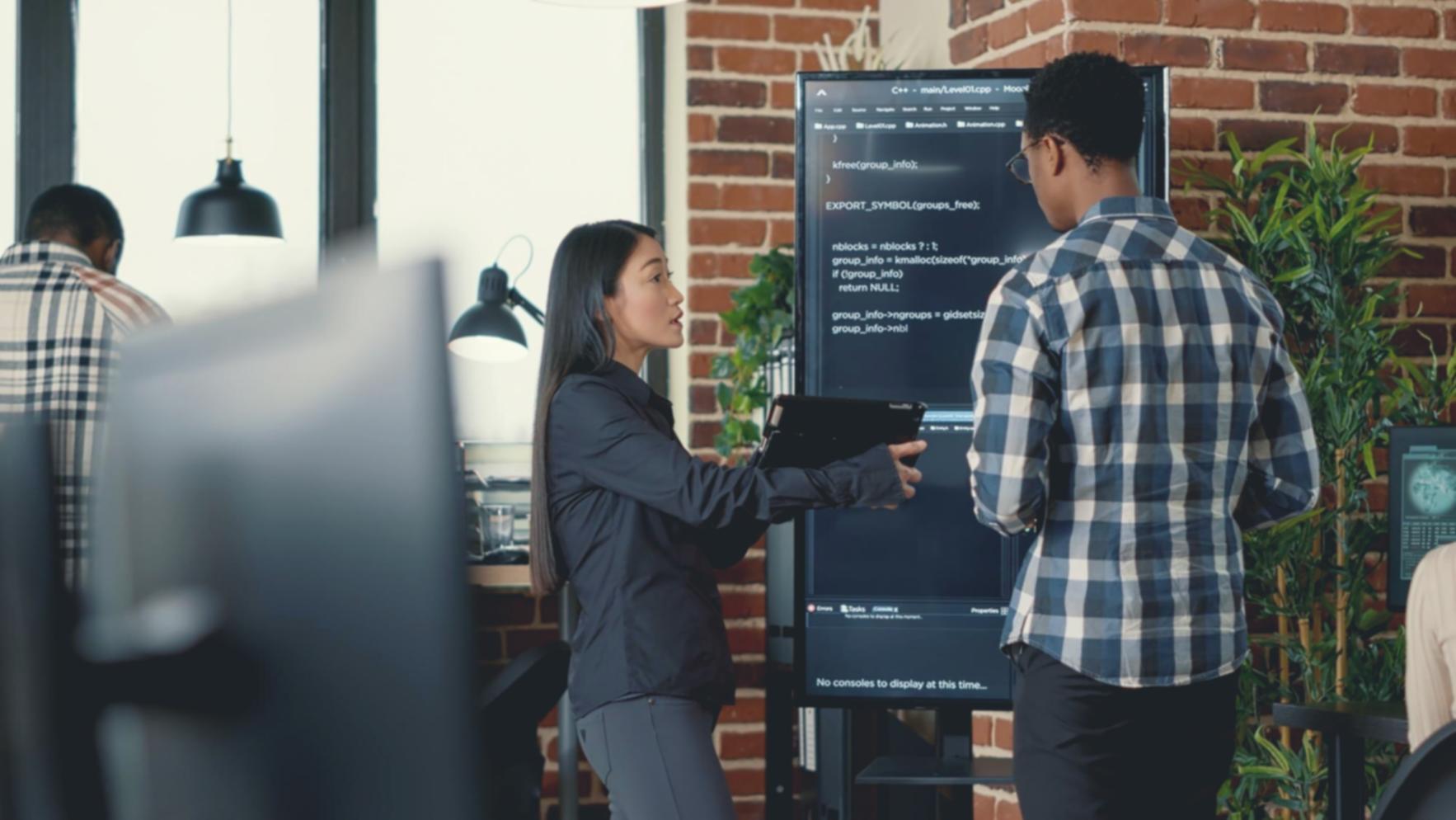 Team collaboration session with developers and testers reviewing software architecture and test strategies